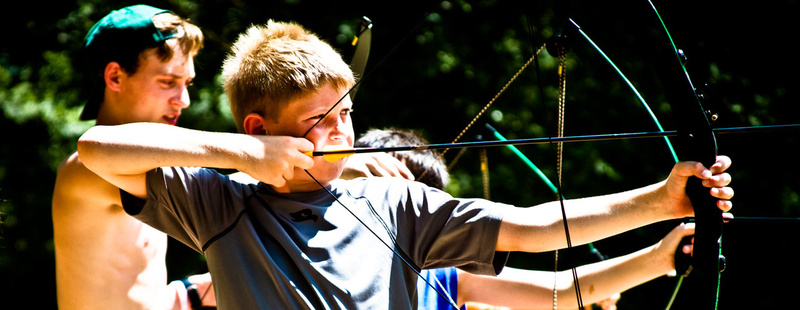 Archery - learn to arch like Robin Hood on our renovated, 14 target archery course. Tanner (6 yrs at camp, 2nd generation camper) pulls back looking for a bullseye.