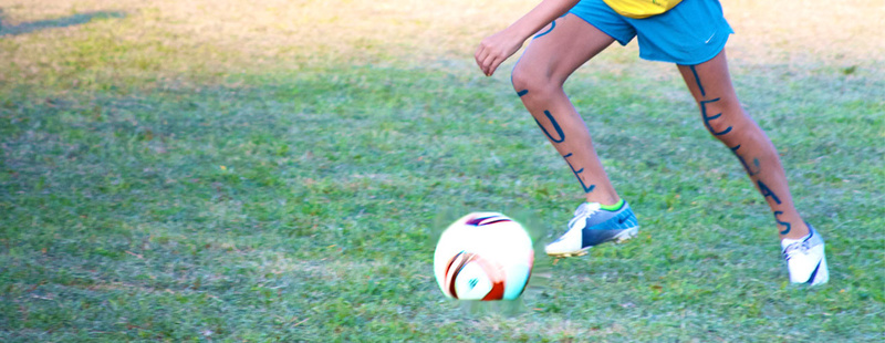 Soccer - Huawni soccer is epic… Anna (7 yrs at Camp) dribbles down the field in her Tejas war paint during Tribal Competition.