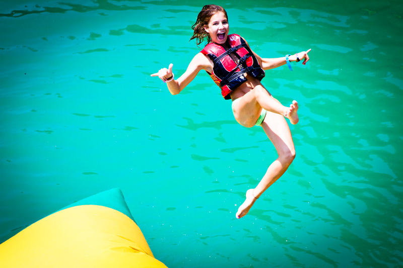 Taighen (10 yrs at camp) soars high from a critter/blob bounce!
