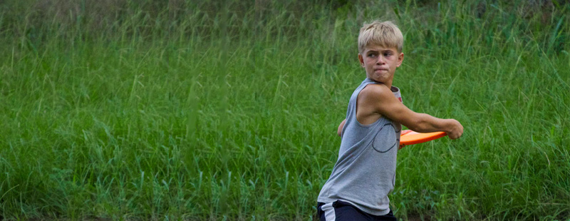 Ultimate Frisbee - working out has never been so much fun, plus you learn how to actually throw a frisbee. Luke (2 yrs at camp) winds up for a big launch.