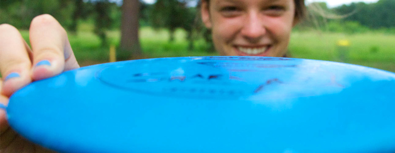 Frisbee Golf - you may find a love for frisbee golf once you play the scenic Huawni Pines course, established in 2003. Claire (9 yrs at camp) smiles during an after supper round.