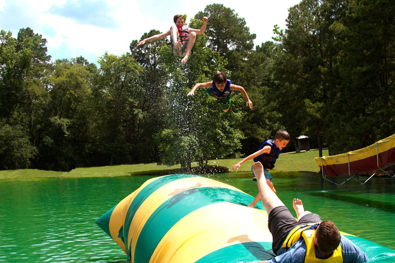 Brett (4 yrs at camp) sends his buddies Evan (3 yrs at camp), Dayton (2 yrs at camp) and Brady (1st yr) airborne on the Critter (blob)!!